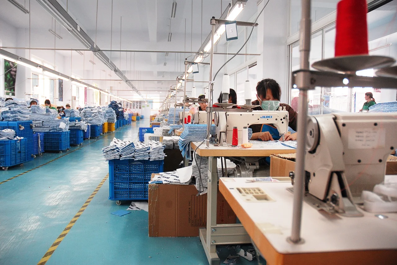 Workers and sewing machines on AquaStar’s Qingdao factory floor