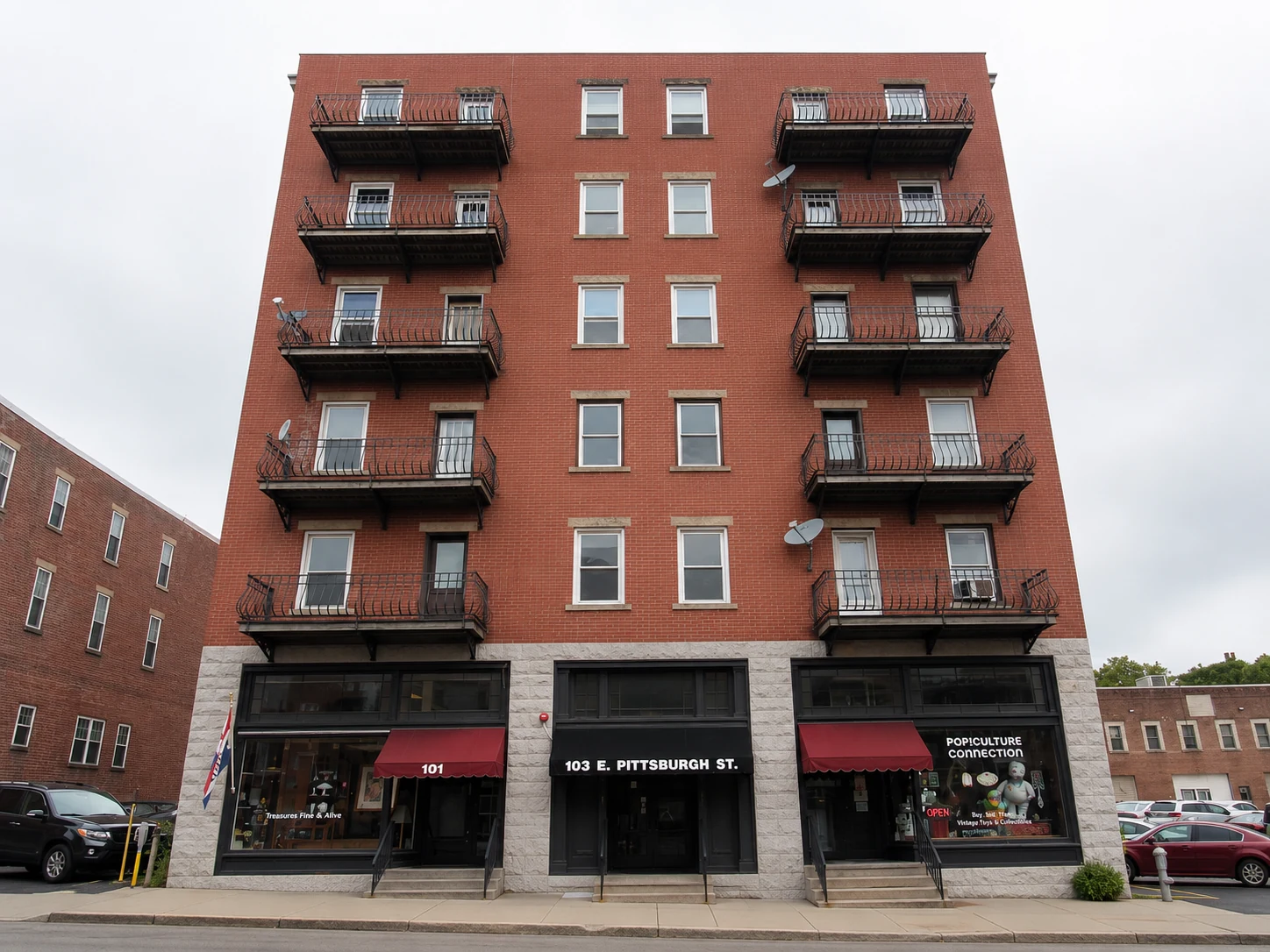 East Pittsburgh Street brick apartment building with ground-floor storefronts